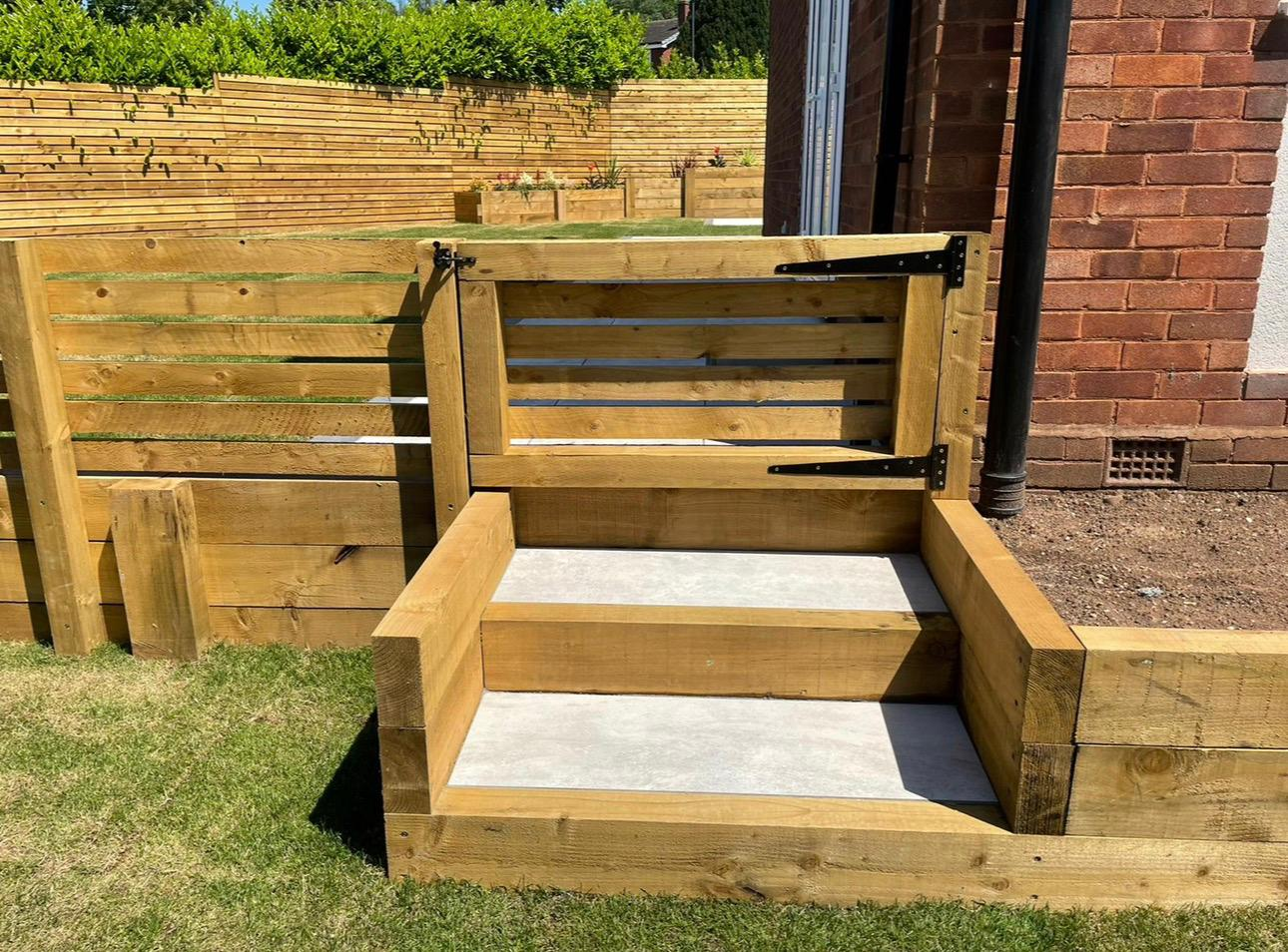 Timber decking with wide step leading to glazed garden room