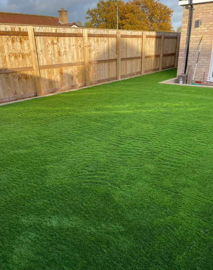 Fresh artificial lawn with timber fencing
